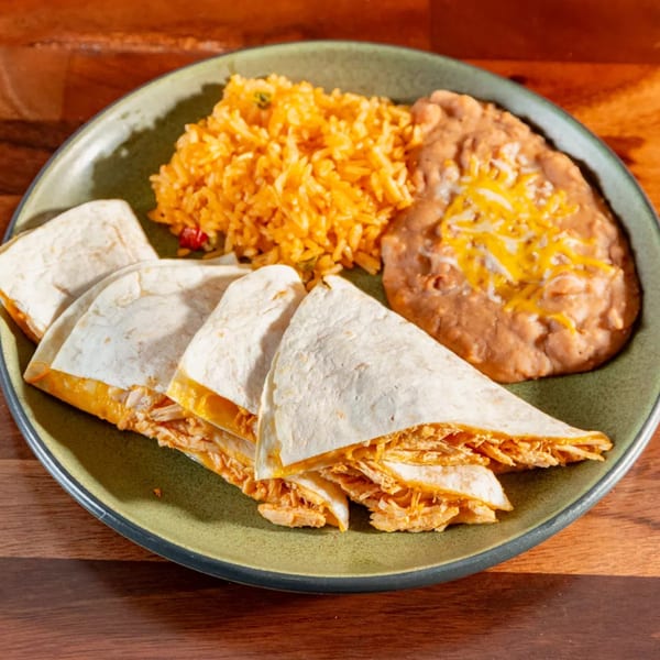 Miguelito's Cocina Mexicana chicken quesadillas, rice, and refried beans with melted cheese on a green plate.